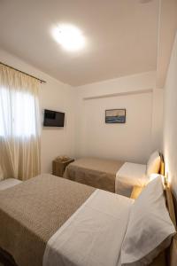 A bed or beds in a room at Filocsenia luxury apartment at tsoutsouras