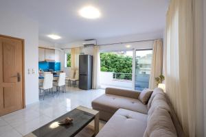 a living room with a couch and a table at Filocsenia luxury apartment at tsoutsouras in Tsoutsouros