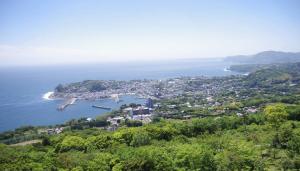 an aerial view of a city and the ocean at so-an morie in Higashiizu