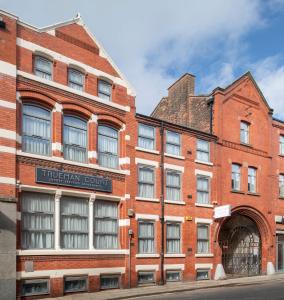 an old red brick building on a street at Trueman Court Luxury Serviced Apartments in Liverpool