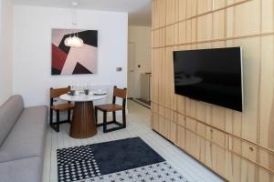 a living room with a tv and a table at Trueman Court Luxury Serviced Apartments in Liverpool