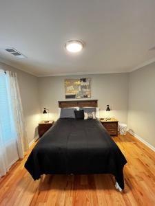 a bedroom with a bed with a black blanket at Atlanta Unit 2 Room 2 - Peaceful Weekend Getaway Private Bedroom & Bathroom in Atlanta