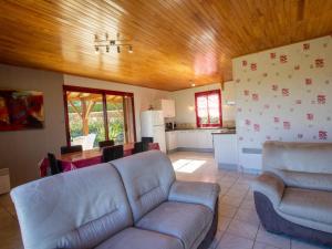 a living room with a couch and a kitchen at Gîte Domme, 4 pièces, 6 personnes - FR-1-616-3 in Domme