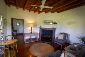 a living room with a fireplace and a table at The Barracks, Tocal in Paterson