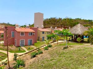a group of houses with a water tower in the background at sweet home ixtapa comfort in Ixtapa