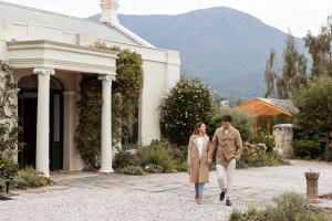 a man and a woman walking in front of a house at Islington Hotel in Hobart