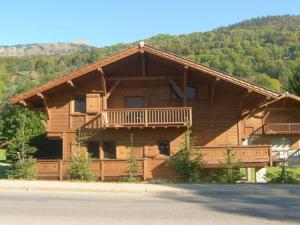 a log cabin with a porch and a balcony at Chalet Samoëns, 8 pièces, 14 personnes - FR-1-629-1 in Samoëns