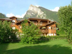 a large house with a mountain in the background at Appartement Samoëns, 3 pièces, 6 personnes - FR-1-629-17 in Samoëns