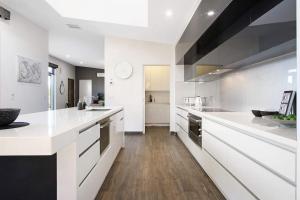 a large white kitchen with white counter tops at Eden Place - Woodlands in Yarrawonga