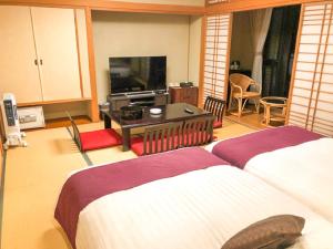 Postel nebo postele na pokoji v ubytování LiVEMAX RESORT Jogasaki Kaigan