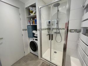 ein Badezimmer mit Dusche und Waschmaschine in der Unterkunft Charmant T2 en front de mer, 4 pers., ascenseur, garage, Wi-Fi - FR-1-361-383 in Granville + 13 Fotos