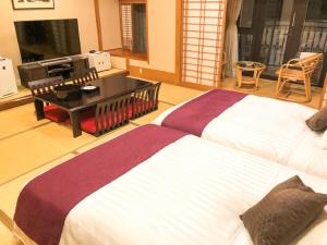 Postel nebo postele na pokoji v ubytování LiVEMAX RESORT Jogasaki Kaigan