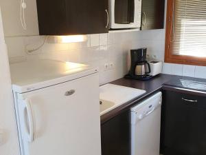 a kitchen with a white refrigerator and a microwave at Chalet Les Orres, 3 pièces, 6 personnes - FR-1-322-434 in Les Orres