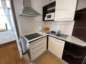 a small kitchen with a sink and a microwave at Appartement Les Angles, 2 pièces, 6 personnes - FR-1-295-141 in Les Angles