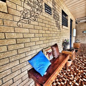 
a person sitting on a bench in front of a building at Raceview Motor Inn in Toowoomba
