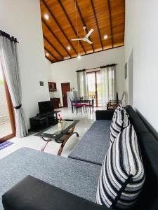 a living room with a couch and a table at Happy Homes in Kiribathgoda