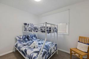 a bedroom with a bunk bed and a chair at Regency Court 4 in The Entrance