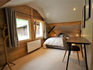 a bedroom with a bed and a desk and a table at Chalet Arêches-Beaufort, 5 pièces, 8 personnes - FR-1-342-243 in Beaufort