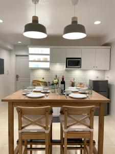 a kitchen with a large wooden table with two chairs at CRIB 227: Modern Fresh Vibe Condo in Olongapo
