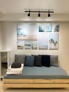 a bed in a room with pictures on the wall at CRIB 227: Modern Fresh Vibe Condo in Olongapo