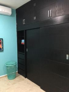 a closet with black cabinets and a blue wall at Dream Lagoons in Cancún