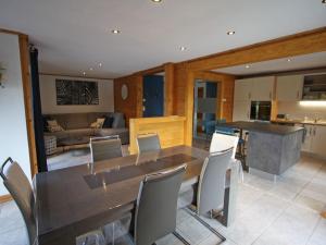 a kitchen and living room with a wooden table and chairs at Gîte Rupt-sur-Moselle, 4 pièces, 6 personnes - FR-1-589-387 in Rupt-sur-Moselle