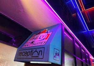 a neon sign hanging from the ceiling of a building at Philly Inn & Suites in Philadelphia