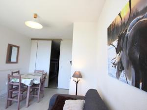 a living room with a couch and a table at Appartement Chamrousse, 2 pièces, 5 personnes - FR-1-549-83 in Chamrousse