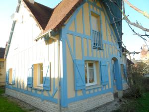 una casa pintada de azul y amarillo en Grande Villa avec Jardin, Proche Plage et Centre de Villers-sur-Mer - FR-1-487-310, en Villers-sur-Mer