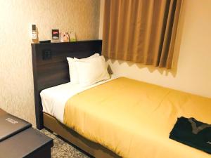 Voodi või voodid majutusasutuse HOTEL LiVEMAX PREMIUM Sapporo Odorikoen toas