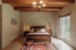 a bedroom with a bed and a large window at Casa La Vina Villas Pokolbin in Pokolbin