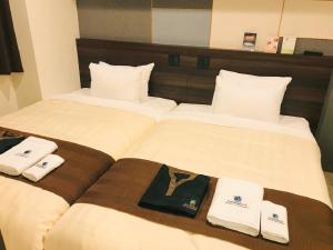 Voodi või voodid majutusasutuse HOTEL LiVEMAX PREMIUM Sapporo Odorikoen toas