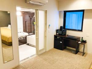 Voodi või voodid majutusasutuse HOTEL LiVEMAX PREMIUM Sapporo Odorikoen toas