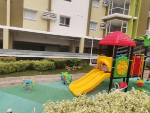 a playground with a slide in front of a building at Mesaverte Residences Afs Suites - Studio in Cagayan de Oro