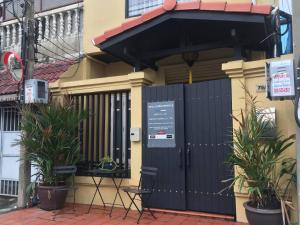 a black gate in front of a house with plants at Fabulous Dasiri Townhouse With 5 Bedrooms in Bangkok