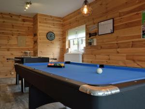 a pool table in a room with wooden walls at Splendid Holiday Home in Stavelot with Sauna in Stavelot