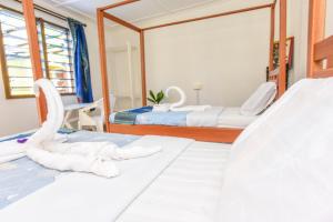 Postel nebo postele na pokoji v ubytování Enkayz Mombasa