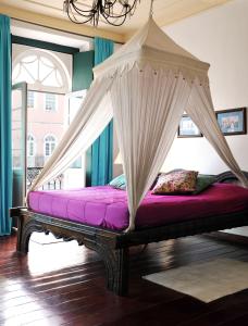a bed with a canopy on top of it at Hotel Villa Bahia in Salvador