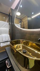 eine goldene Badewanne im Bad mit einem Bett in der Unterkunft KND Living Concept - Studio in Iraklio