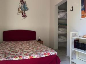 a bedroom with a bed with a red head board at Maison vendéenne rénovée, accès direct plage, terrasses, BBQ, parking gratuit - FR-1-336-123 in Longeville-sur-Mer