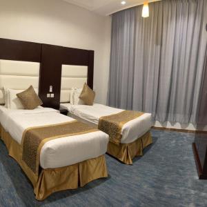 a hotel room with two beds in a room at فندق فربيون ابها - Ferbion Hotel Abha in Abha