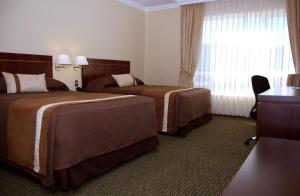 Ένα ή περισσότερα κρεβάτια σε δωμάτιο στο Hotel Diego de Almagro Temuco