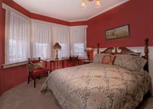 a bedroom with a large bed and red walls at Inn San Francisco in San Francisco