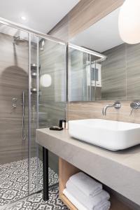 a bathroom with a sink and a shower at Hotel Roumani in Spetses