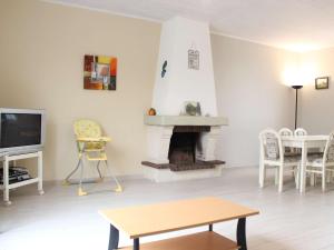 a living room with a fireplace and a table and a tv at Maison bord de mer à la Cotinière, 3 chambres, terrasse et parking, 6 couchages - FR-1-246A-101 in Saint-Pierre-dʼOléron