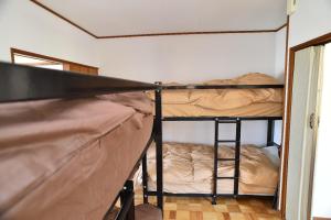 a room with two bunk beds and a mirror at Greenheim Suitengushita / Vacation STAY 252 in Otaru