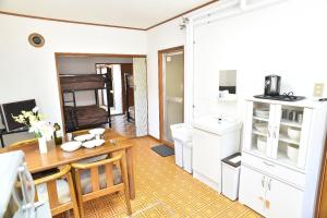 a kitchen with a table and a dining room at Greenheim Suitengushita / Vacation STAY 252 in Otaru