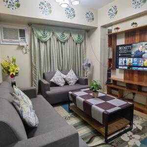 a living room with a couch and a tv at Avida Davao Condos, downtown CM Recto Avenue, Davao City in Davao City