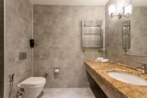 a bathroom with a sink and a toilet at The Grand Gloria Hotel in Batumi +38 photos