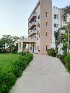 a building with a walkway in front of a building at Sun Stone Hotel & Club - Jawai in Sheoganj